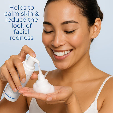 Woman holding a skincare product with text about skin calming and reducing facial redness.