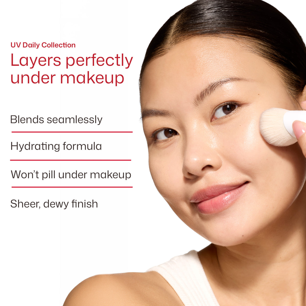 Close-up of a woman applying makeup with a brush on her cheek, with text on the left reading 'UV Daily Collection' and 'Layers perfectly under makeup' plus feature callouts.