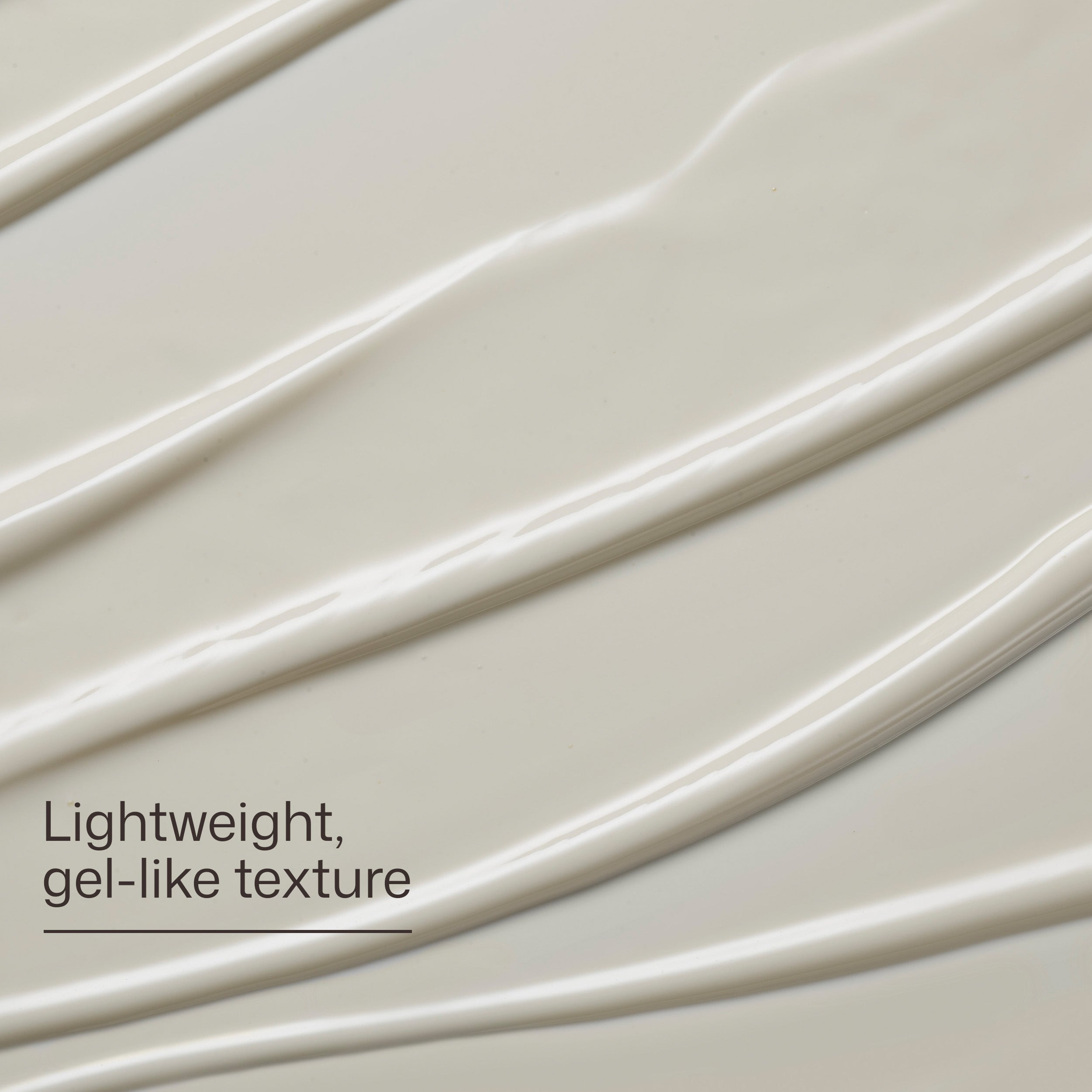 Close-up of a gel-like texture with wavy lines on a light background.